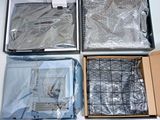 three boxes of electronic equipment sitting on top of a white table