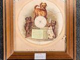 framed picture of a clock with a picture of a dog on it