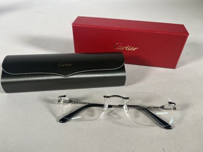 cartier eyeglasses with box and case on table