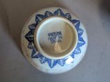 a small blue and white vase on a table