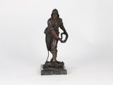 bronze statue of a man holding a baseball glove and a ball