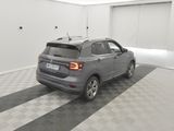 the back end of a grey car parked in a garage