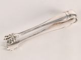 a silver spoon with a flower on it on a white surface
