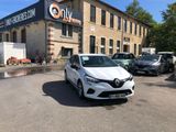 a white car parked in front of a building