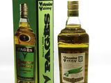a bottle of alcohol sitting next to a box on a white surface