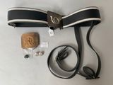 a belt, earphones, and a wooden block on a table