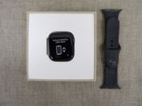 a black apple watch sitting next to a white apple watch