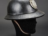a black helmet with a silver flower on it sitting on top of a mannequin head