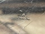 a close up of a silver plate with a picture on it
