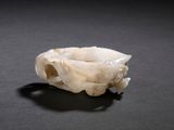 a close up of a carved animal skull on a table