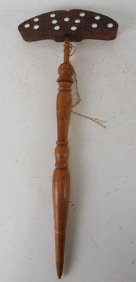 an image of a wooden hammer hanging on a wall