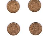 four different types of gold coins on a white surface