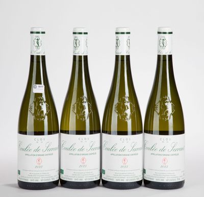 three bottles of wine are lined up on a white surface