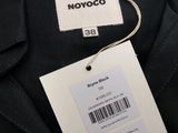 a close up of a label on a black jacket with a barcode on it