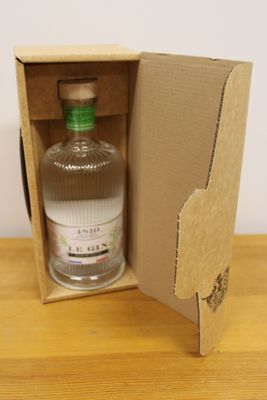 a bottle of gin in a cardboard box on a table