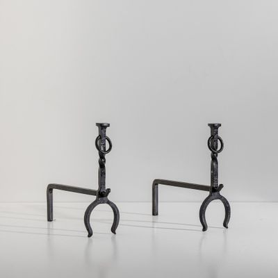 a pair of black iron candlesticks on a white background