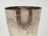 a silver cup that has a design on the inside of it