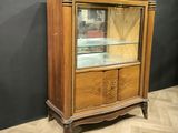 an antique wooden display cabinet with glass doors and drawers