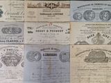 several old and old paper documents on a wooden table