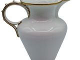 an image of a white pitcher with gold trim on a white background