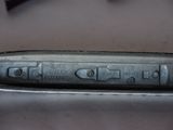 a close up of a metal object with writing on it