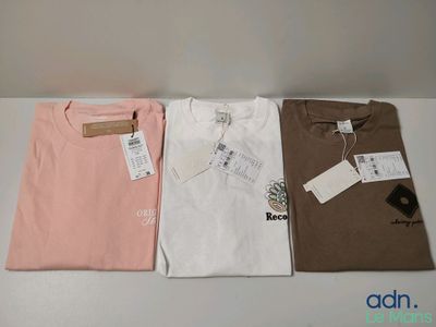 three t - shirts are sitting on a table with tags on them