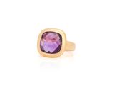 a close up of a gold ring with a purple stone
