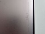 the back of a silver laptop computer sitting on top of a table