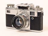 a silver and black camera on a white background