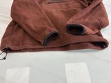 the jacket is brown and has black zippers on it