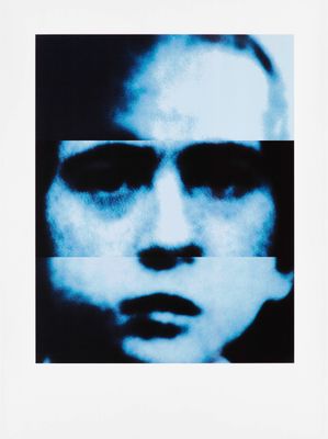 a black and white photo of a man ' s face with a blue background