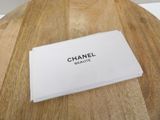 a box of chanel beauty sitting on a wooden table