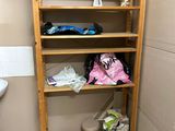 a wooden shelf in the corner of a bathroom