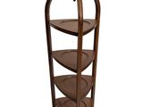 an image of a three tiered shelf with a bird on it