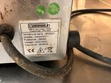 a close up of a machine with a cord attached to it