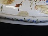 a white plate with a bird and flowers design on it
