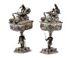 pair of silver plated figurines of a man and a woman with a basket