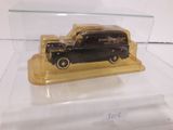 a black car in a clear case on a white surface