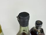 three bottles of liquor sitting next to each other on a table