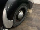 a black and silver car parked in a garage