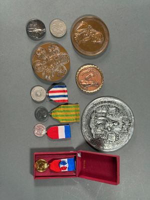 a lot of coins and medals that are on the table