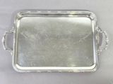 silver plated serving tray with handles and handles on a table