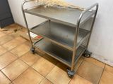 a metal cart with a broom on top of it