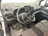 the interior of a small car with a steering wheel and dashboard