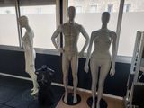three mannequins that are standing in front of a window