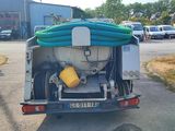 a truck that has a hose on the back of it
