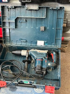 a blue tool box with a drill and other tools in it