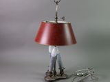 a lamp that is sitting on a table with a red shade
