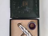 a bottle opener in a box with a corkscrew in it