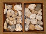 two wooden boxes filled with rocks sitting on top of a carpeted floor